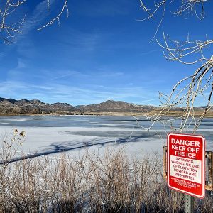 Frozen lake with "Danger Keep of the Ice" sign