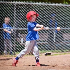 Youth swings at a baseball