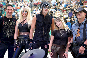 Group picture of That Eighties Band with crowd in background.