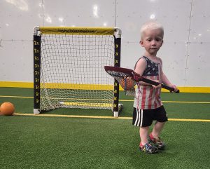 Little boy holding a lacrosse stick
