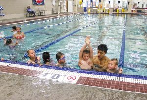 Children taking swimming lessons