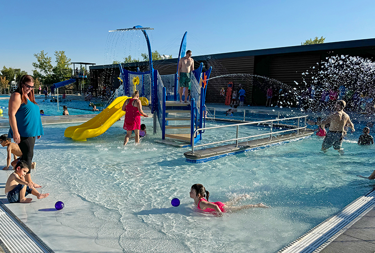 Children playing in the zero depth entry area of Columbine West Pool.