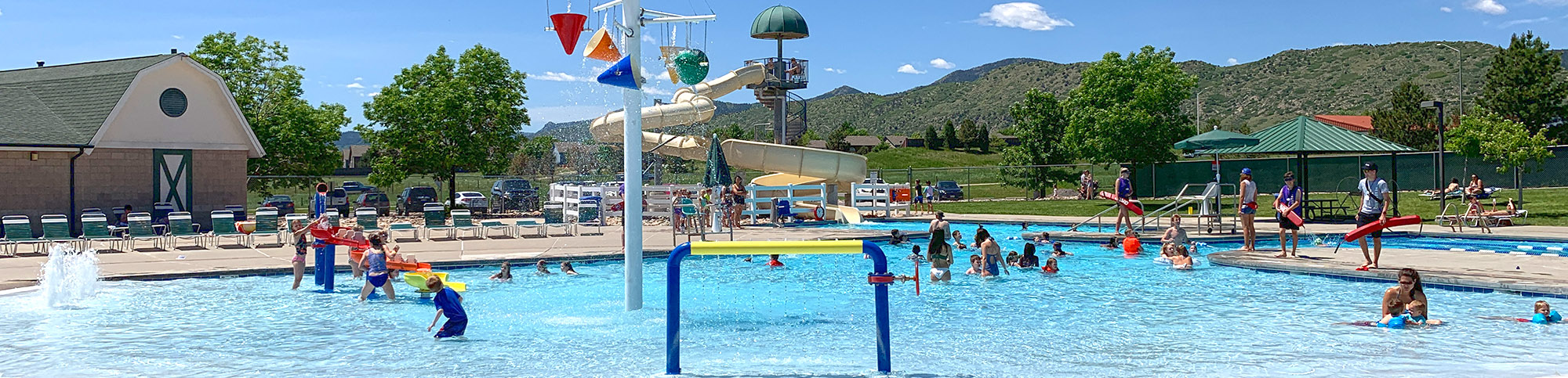 A variety of pool users in Deer Creek Pool swimming, floating and lounging.