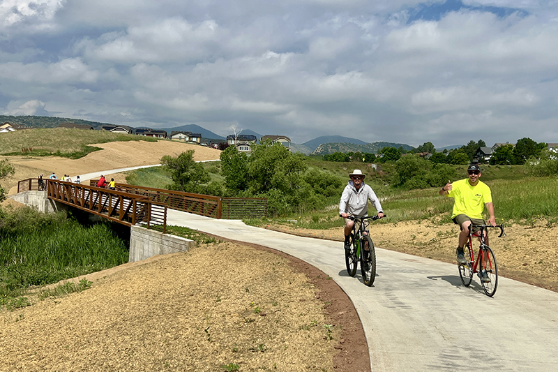 Two men on bicycles riding on the Dutch Creek Trail.